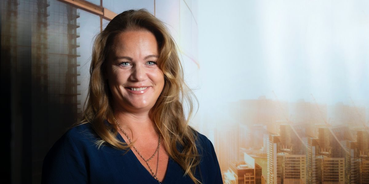 Jenny Larsson på Hitachi ABB Sverige mot utsikt från kontor i skyskrapa i motljus
