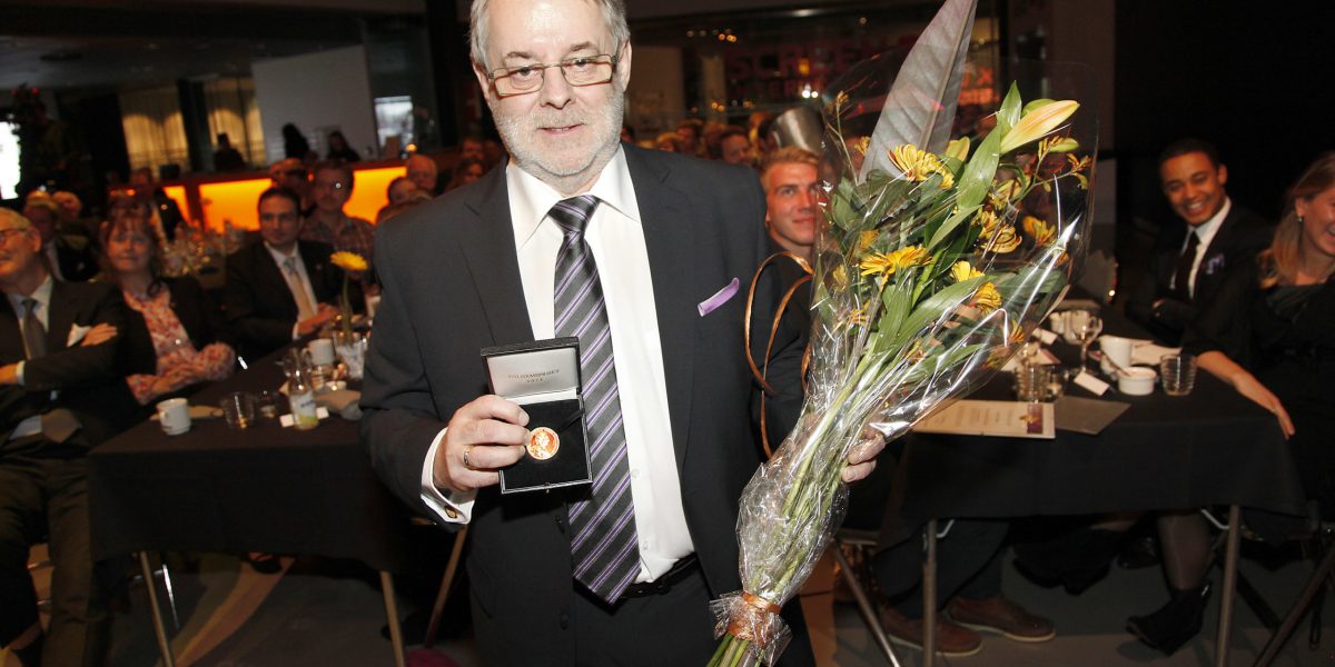 businessman holding an award